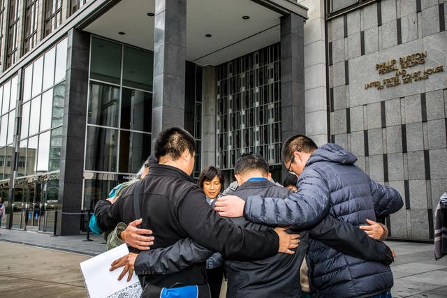 Reverend Deborah Lee prays outside a federal building in San Francisco before attending a hearing related to the deportation of an undocumented immigrant from Cambodia