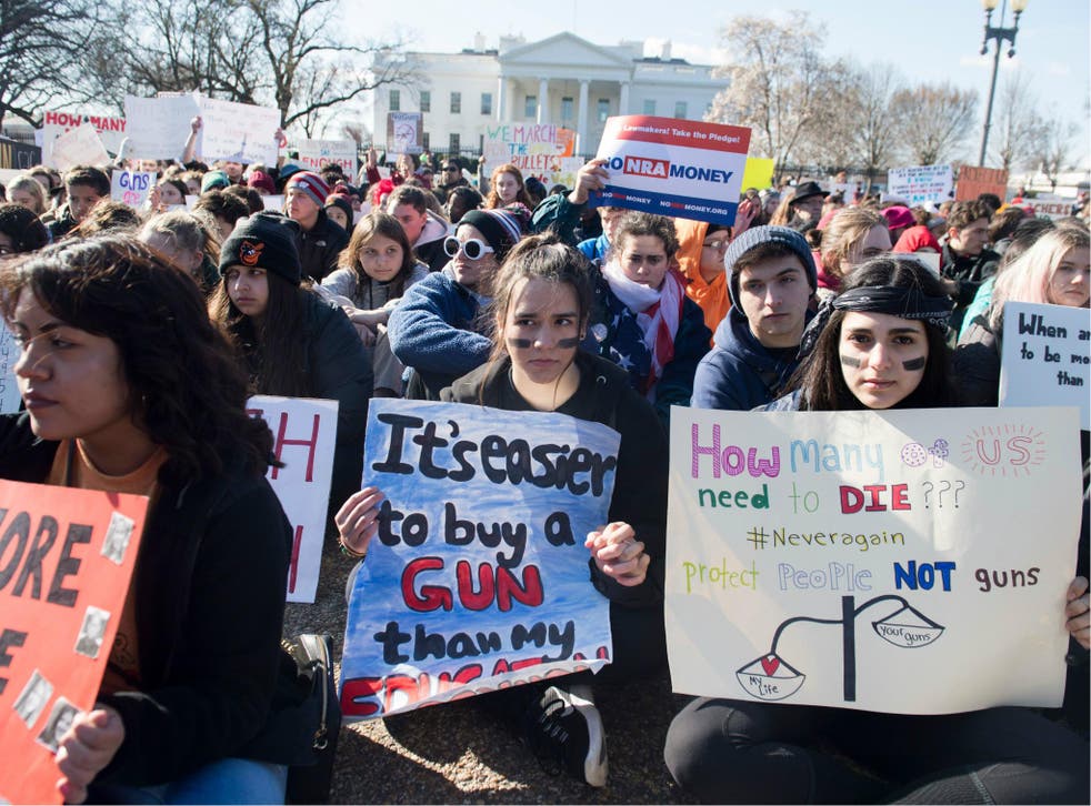 Thousands of local students sit for 17 minutes in honour of the 17 people killed in Parkland, Florida, during a nationwide student walkout for gun control in front the White House on 14 March 14, 2018.
