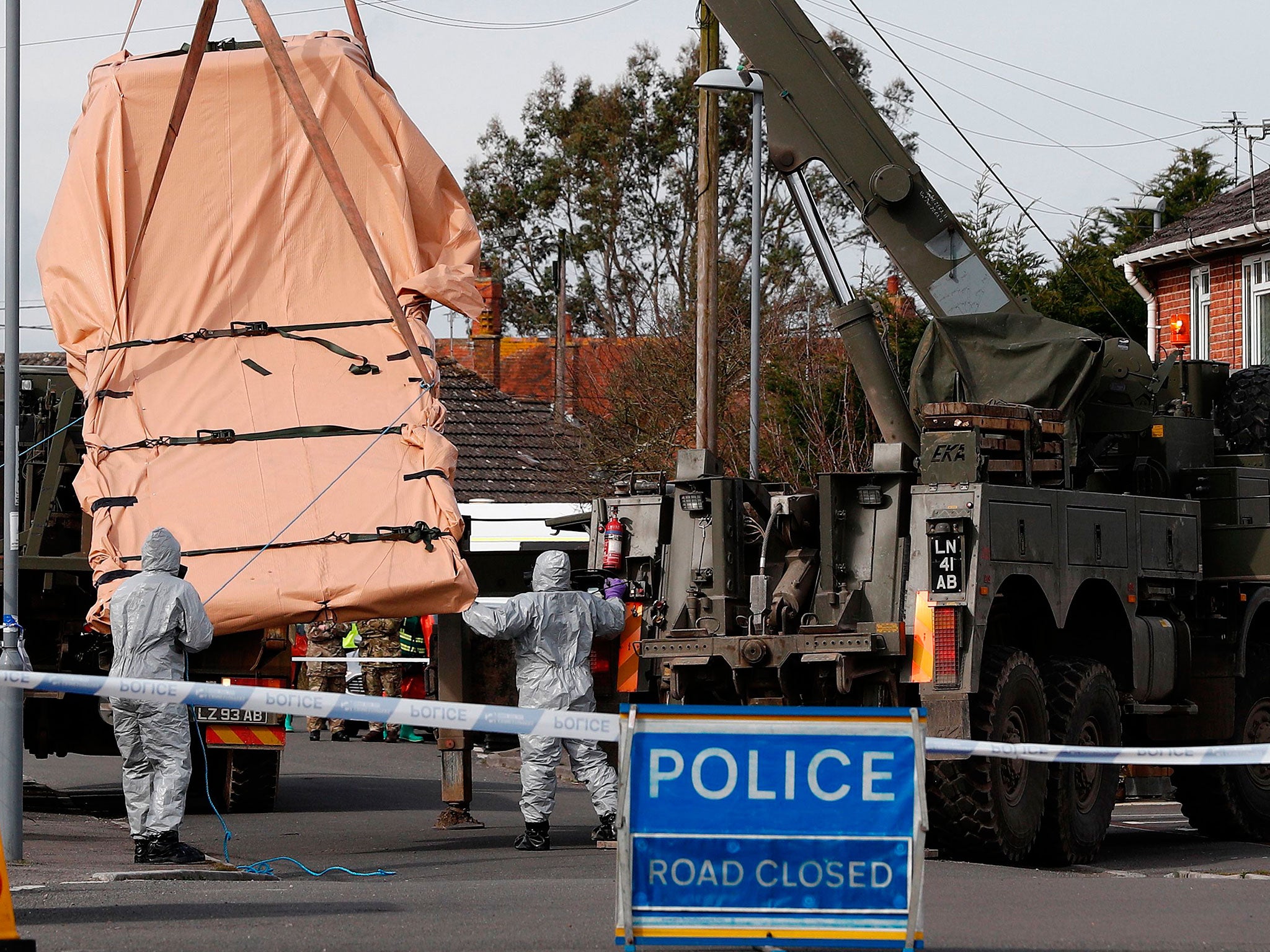 Soldiers wearing protective clothing load a recovery lorry onto an Army vehicle in Gillingham, Dorset, as part of the investigation into the nerve agent attack on the Russian double agent