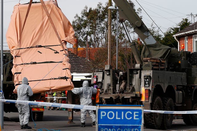 Soldiers wearing protective clothing load a recovery lorry onto an Army vehicle in Gillingham, Dorset, as part of the investigation into the nerve agent attack on the Russian double agent 