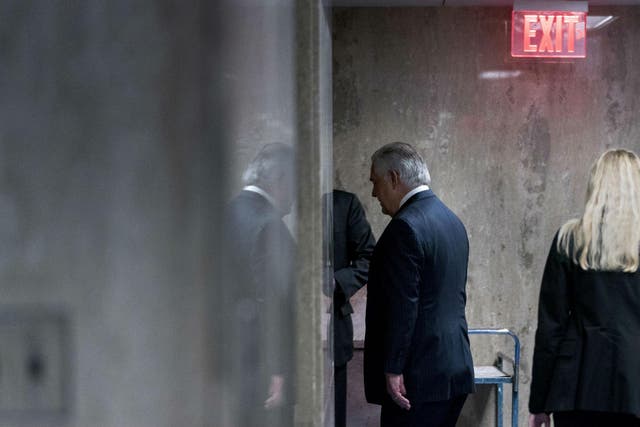 Secretary of State Rex Tillerson walks down a hallway after speaking at a news conference at the State Department