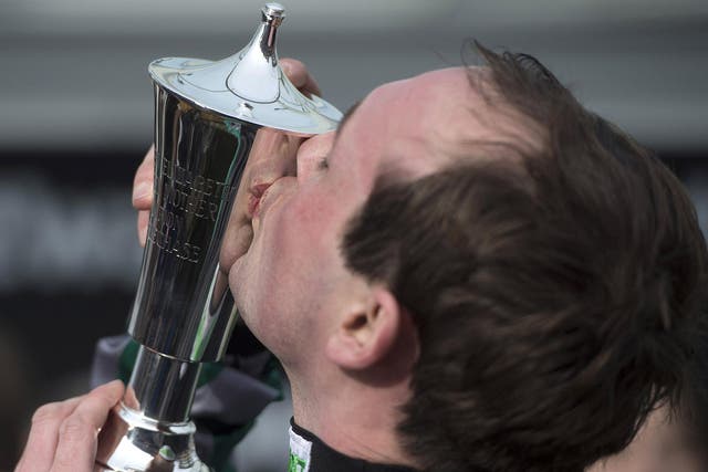 Nico de Joinville kisses the Champions Chase trophy