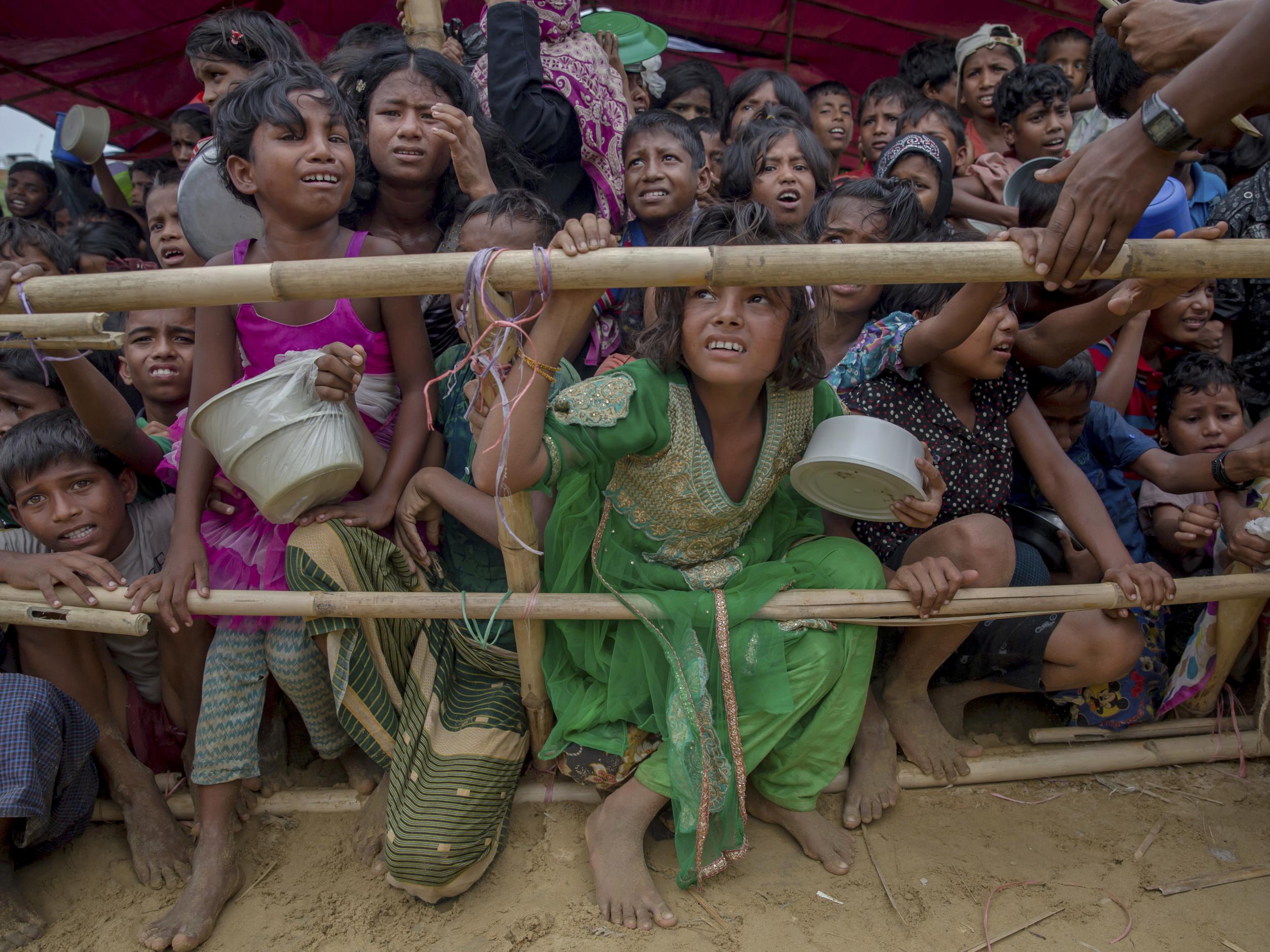 Rohingya Muslim children wait for food handouts distributed by a Turkish aid agency at Thaingkhali refugee camp in Bangladesh