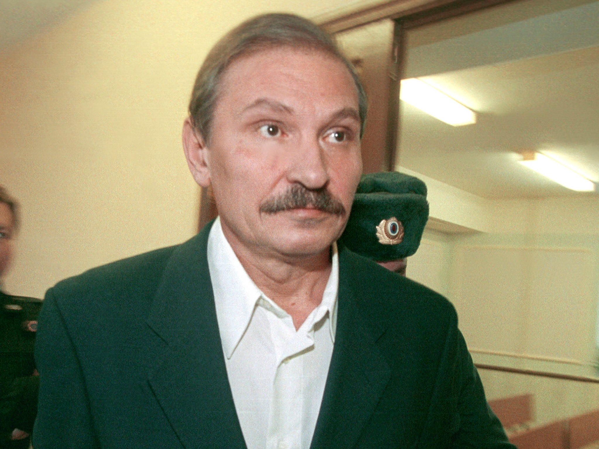 Nikolai Glushkov leaves the Lefortovsky court escorted by police officers, after the judge refused to release him on bail, in Moscow in 2000.