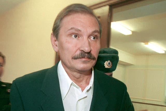 Nikolai Glushkov leaves the Lefortovsky court escorted by police officers, after the judge refused to release him on bail, in Moscow in 2000.