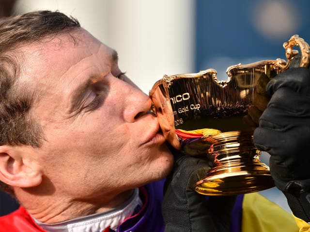 Winning jockey Richard Johnson kisses the Gold Cup