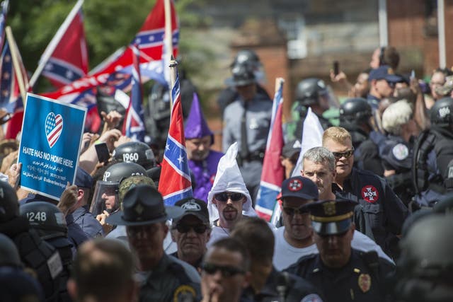 Members of the Ku Klux Klan arrive for a rally, calling for the protection of Southern Confederate monuments, in Charlottesville, Virginia