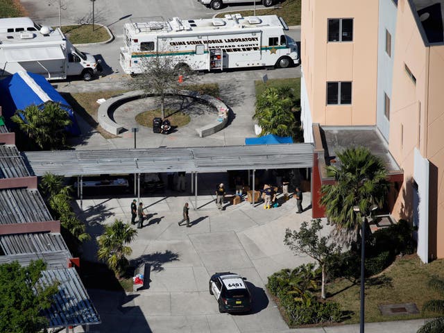 A crime scene mobile laboratory vehicle is parked at Marjory Stoneman Douglas High School following the shooting.