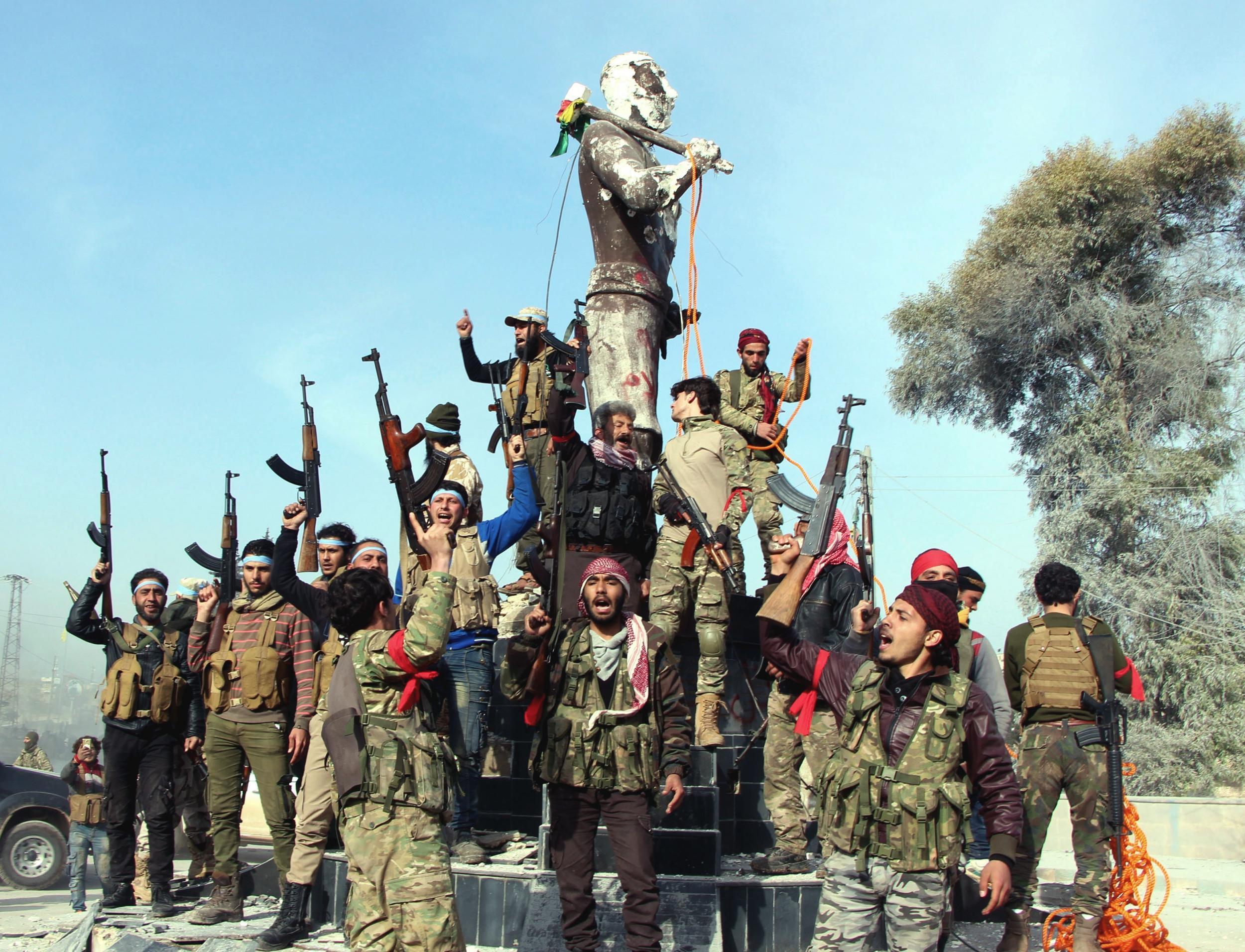 Soldiers prepare to destroy a statue of Kawa, a mythological figure in Kurdish culture (Hasan Kormozitao/DHA-Depo Photos via AP)