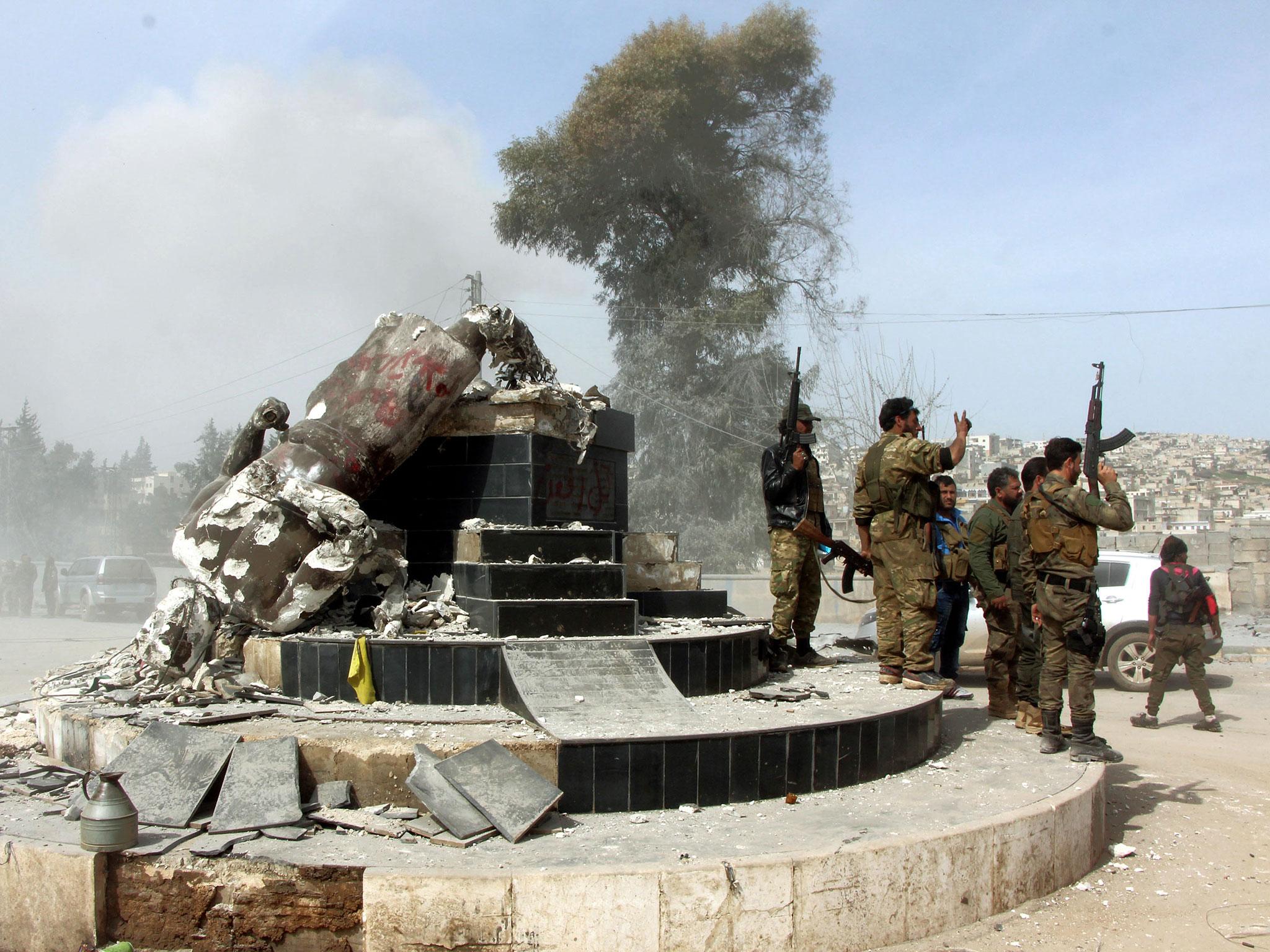 Soldiers destroy the statue (Hasan Kormozitao/DHA-Depo Photos via AP)