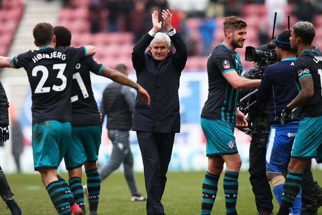 Mark Hughes applauds the Southampton supporters