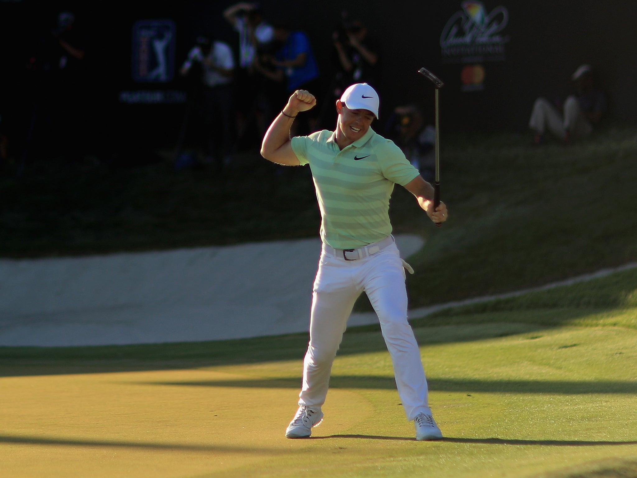 Rory McIlroy punches the air on his way to winning the Arnold Palmer Invitational at Bay Hill