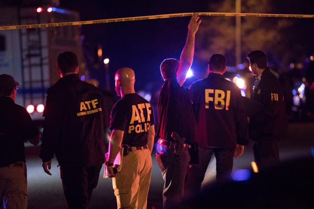 Police and FBI investigators at a cordon near the site of an explosion in south-west Austin
