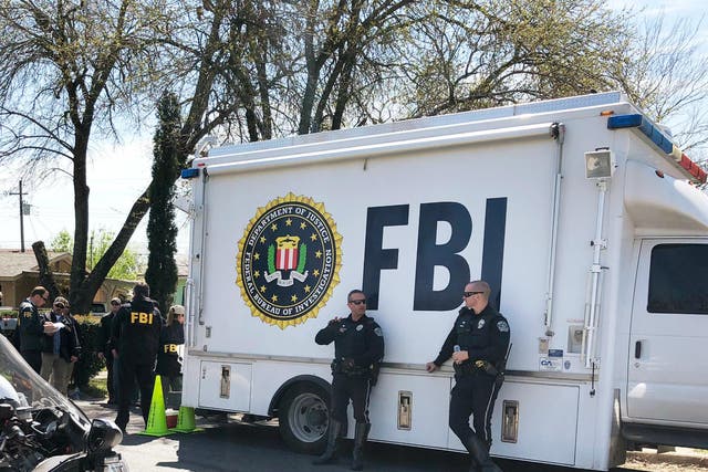 FBI agents are seen near a home that was hit with a parcel bomb in Austin, Texas, 13 March 2018.