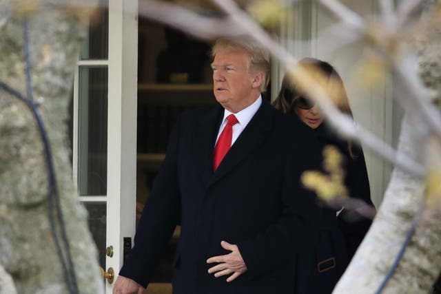 Donald Trump exits the White House with his wife, First Lady Melania Trump