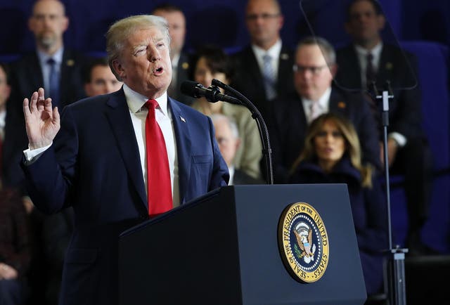 President Donald Trump speaks to supporters and local politicians at an event at Manchester Community College