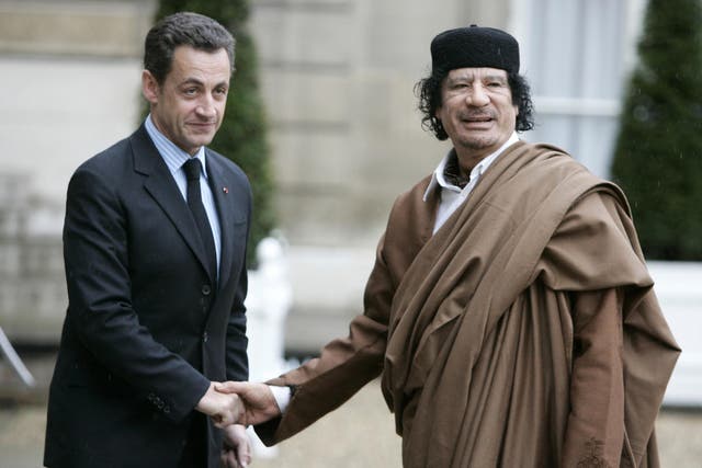 Former President Nicolas Sarkozy greets late Libyan leader Colonel Muammar Gaddafi at the Elysee Palace in Paris in 2007