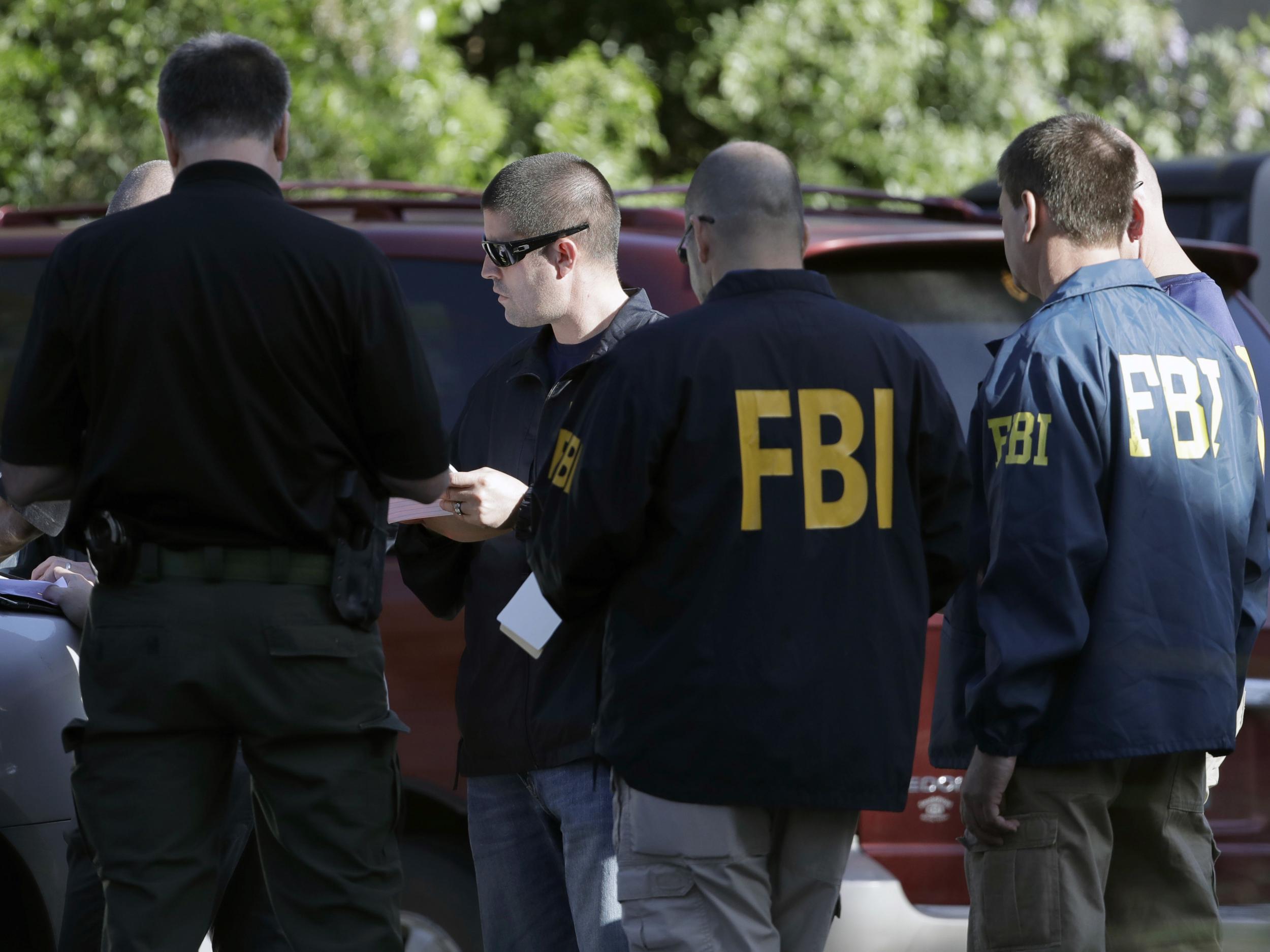 FBI agents work at a scene near the site of Sunday's explosion