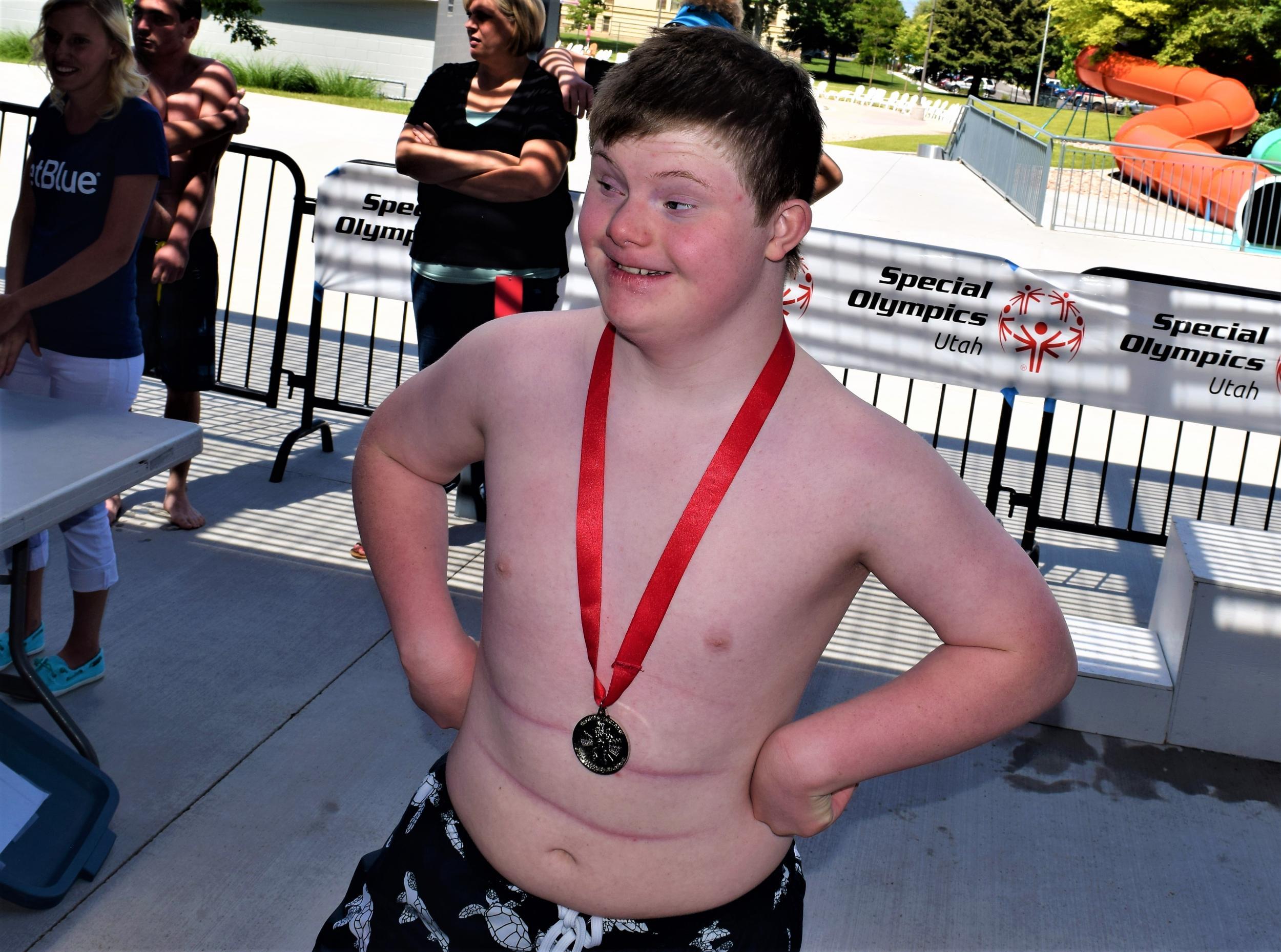 Logan with a medal awarded by the Boy Scouts of America (Chad Blythe)