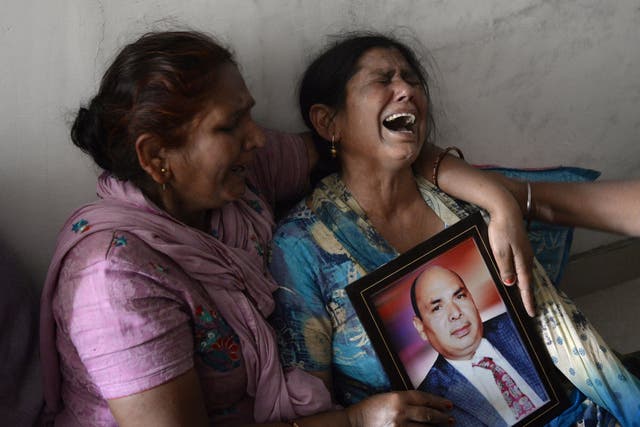 Gyan Kaur holds a photograph of her husband Balwant Rai after hearing confirmation of his death