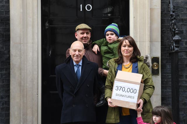 <p>Six-year-old Alfie Dingley, his parents Drew Dingley and Hannah Deacon and actor Sir Patrick Stewart (left) walk up Whitehall in London before handing in a petition to Number 10 Downing Street asking for Alfie to be given medicinal cannabis to treat his epilepsy</p>