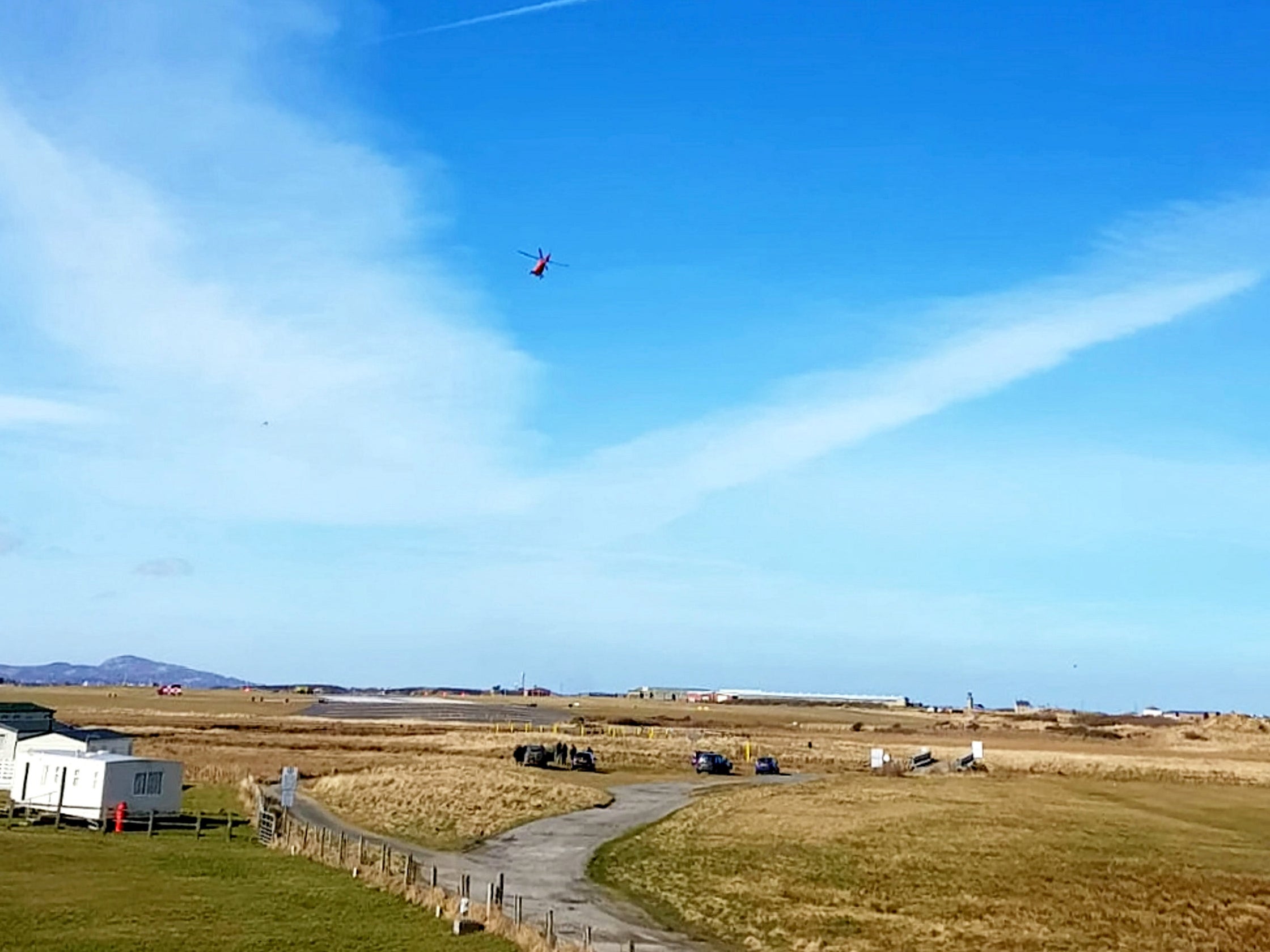 A helicopter is seen at RAF Valley after a Red Arrows Hawk jet crashed (SWNS)