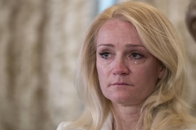 Rocxanne Deschamps sheds tears during a news conference