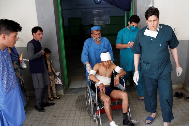 A cares for an injured person in a hospital after the blast.