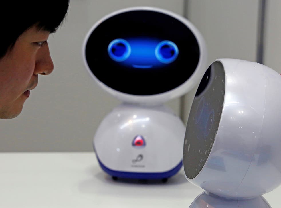 A staff member demonstrates Chinese company U-Chain AI’s robot ‘Genie’, designed for elderly care, last Wednesday as part of Tokyo Care Week
