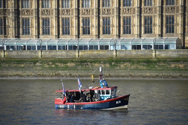 Nigel Farage throws two crates of haddock into the Thames outside Parliament in protest at the Brexit betrayal of the fishing industry