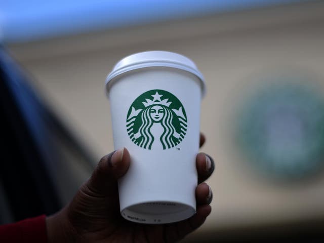A woman holds a Starbucks coffee cup in Silver Spring, Maryland