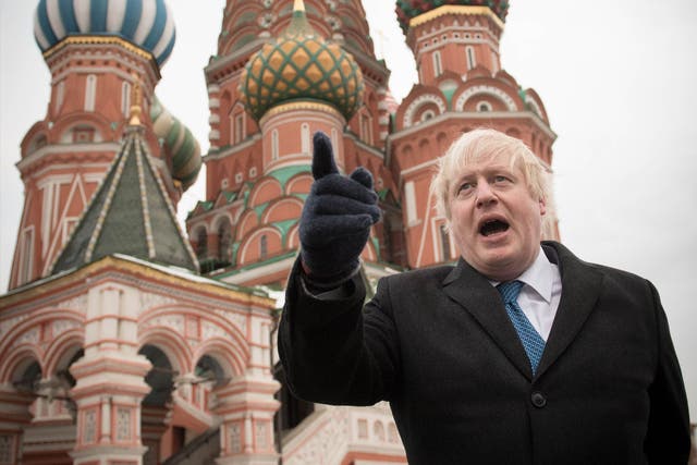 Boris Johnson stands in front of St Basil's Cathedral during a visit to Moscow's Red Square on 22 December 2017