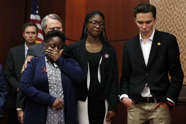 Stacey-Ann Llewellyn, left, is comforted by her daughter, Parkland, Florida school shooting survivor Aalayah Eastmond, as David Hogg, a student at Marjory Stoneman Douglas High School, reacts while a librarian from the school recounts her experience during the shooting, on Capitol Hill in Washington