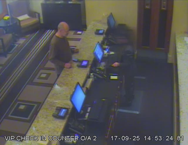 A security camera image shows Stephen Paddock at the VIP counter checking into the Mandalay Bay hotel in Las Vegas
