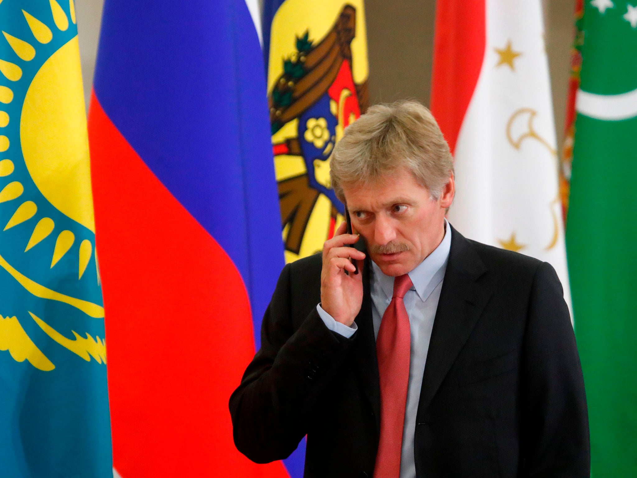 Kremlin spokesman Dmitry Peskov speaks on the phone