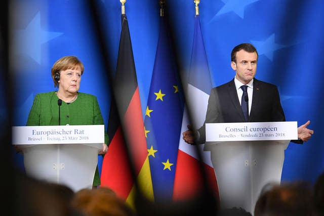 Emmanuel Macron, right, and Angela Merkel, at a media conference following an EU summit in Brussels; both Germany and France are due to announce action against Moscow 'shortly'