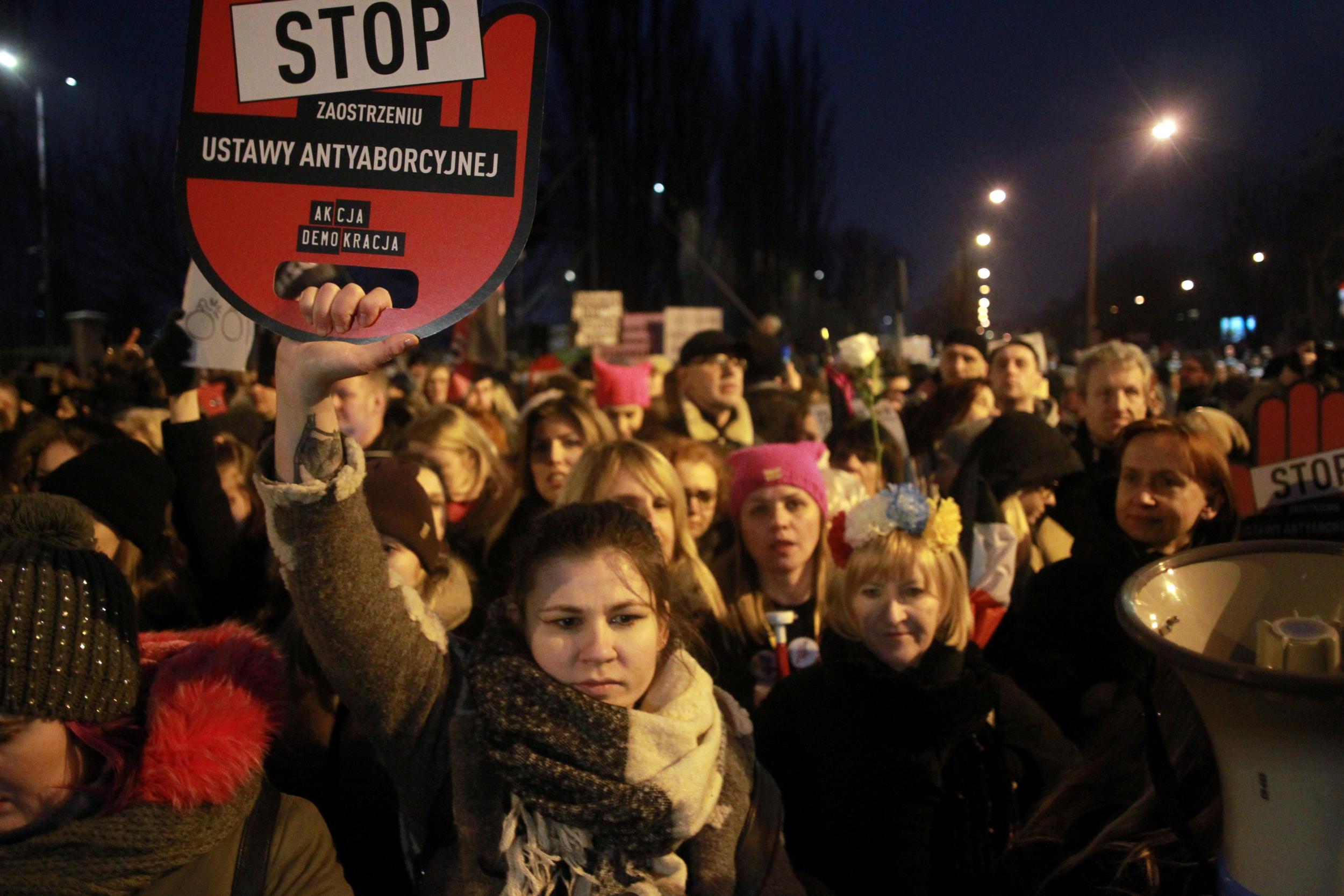 People gather to protest against plans to further restrict abortion laws in Warsaw