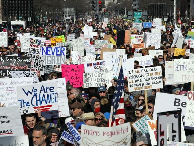 Crowds of people hold signs advocating gun control on Pennsylvania Avenue, in Washington DC