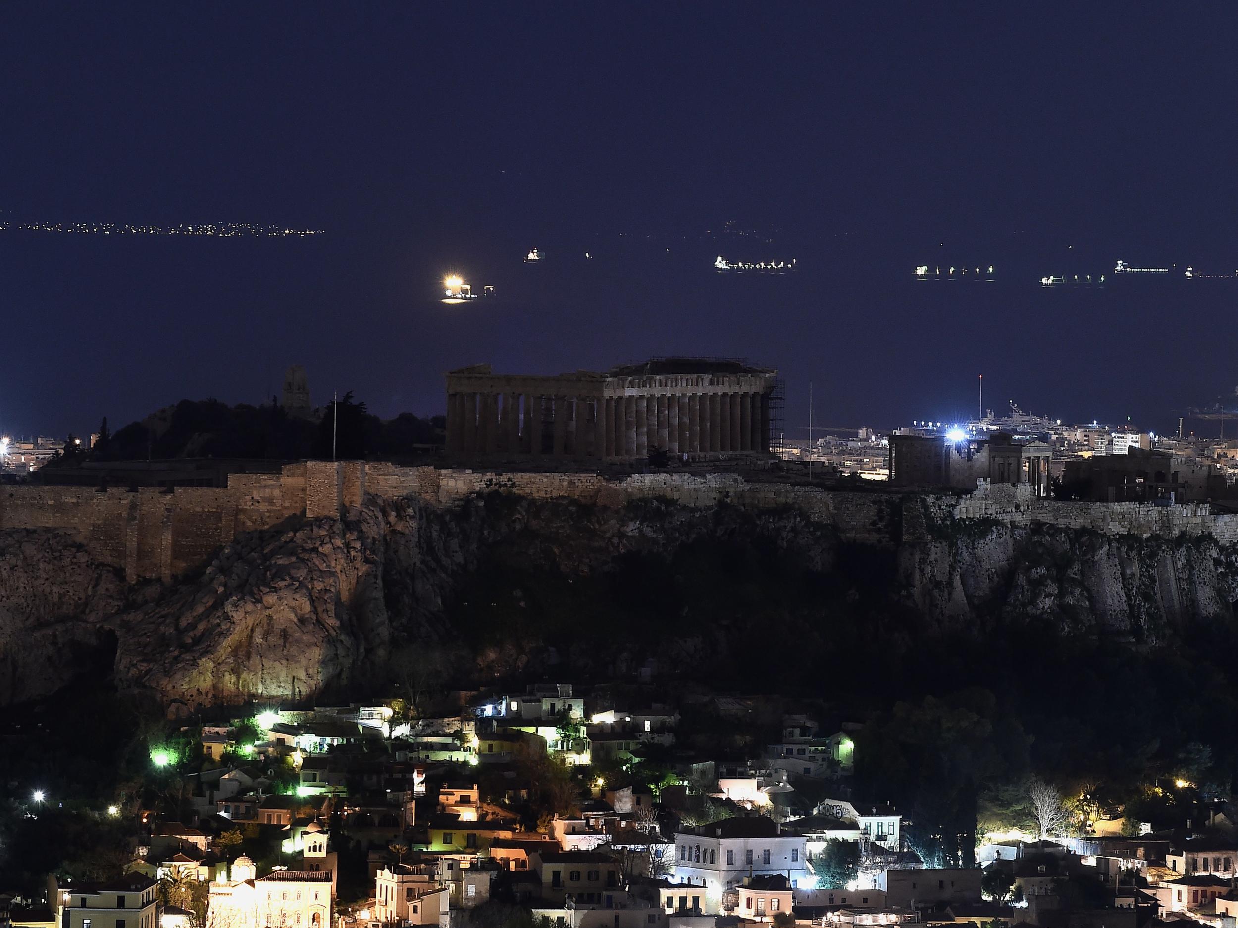 Ancient Temple of Parthenon atop Acropolis hill in the dark during Earth Hour