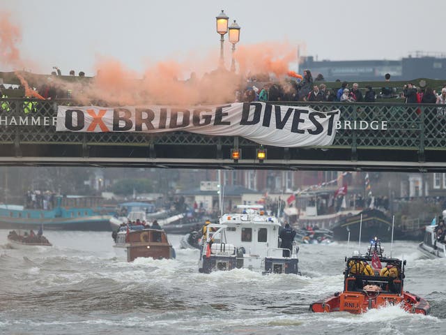 Oxford and Cambridge student environmental activists protest on Hammersmith Bridge in London during the mens Boat Race demanding that "both universities commit to full divestment from fossil fuels".