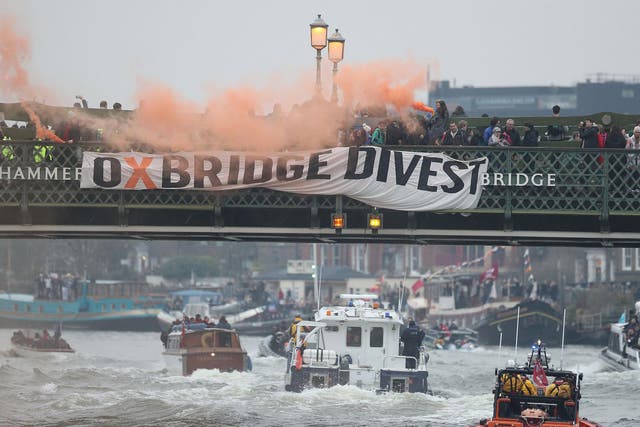 Oxford and Cambridge student environmental activists protest on Hammersmith Bridge in London during the mens Boat Race demanding that "both universities commit to full divestment from fossil fuels".