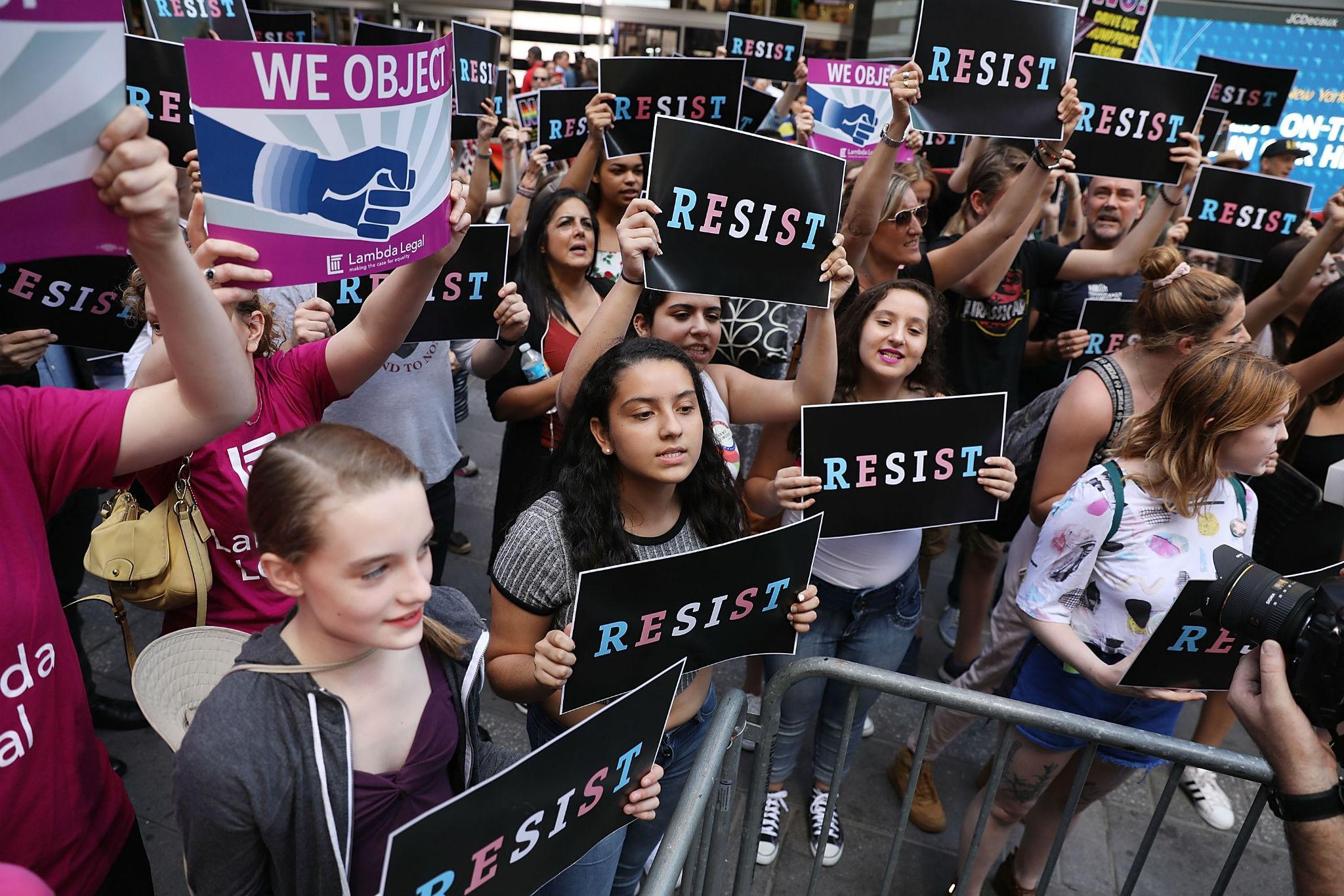 Dozens gather in Times Square in July near a military recruitment centre to protest Donald Trump's decision to reinstate a ban on transgender troops (Getty Images )