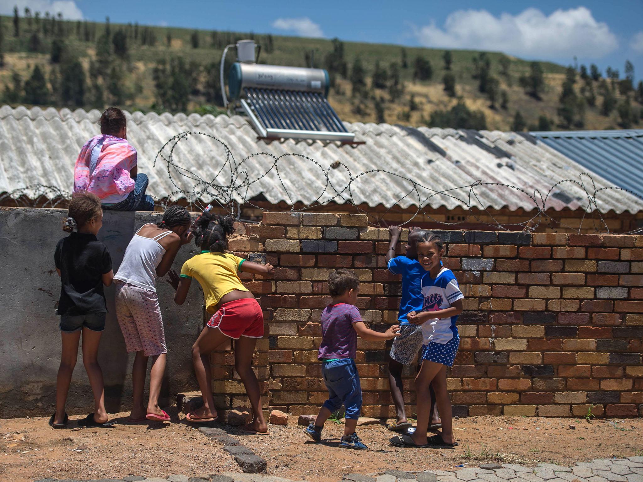 Children playing in the streets of Rivelea, an impoverished suburb in Soweto, Johannesburg (AFP/Getty)