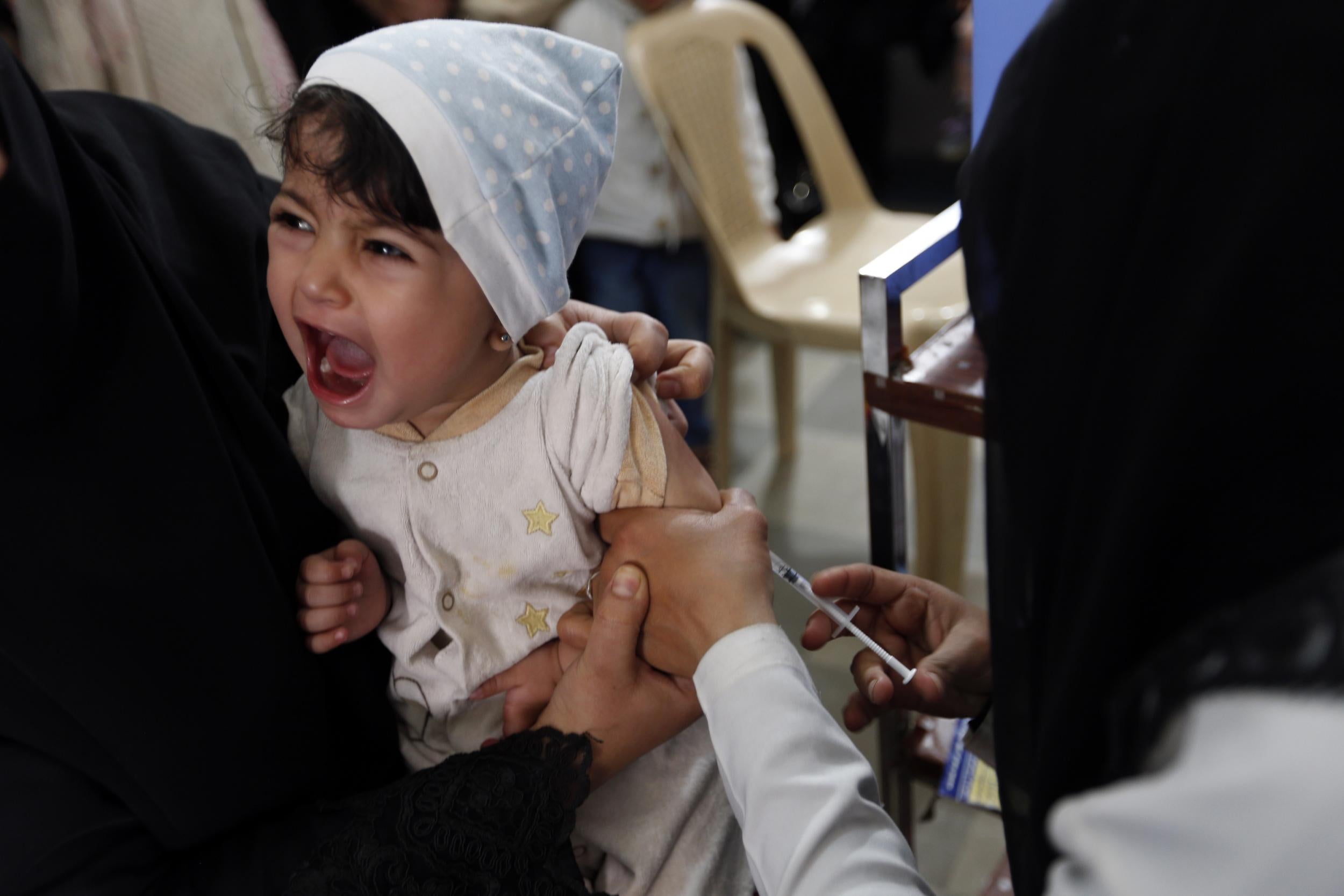 A child receives a diphtheria vaccine at a health centre in the Yemeni capital Sanaa on 18 March 2018. More than 2,300 Yemenis have died of cholera and 70 of diphtheria amid deteriorating hygiene and sanitation conditions, the World Health Organisation says