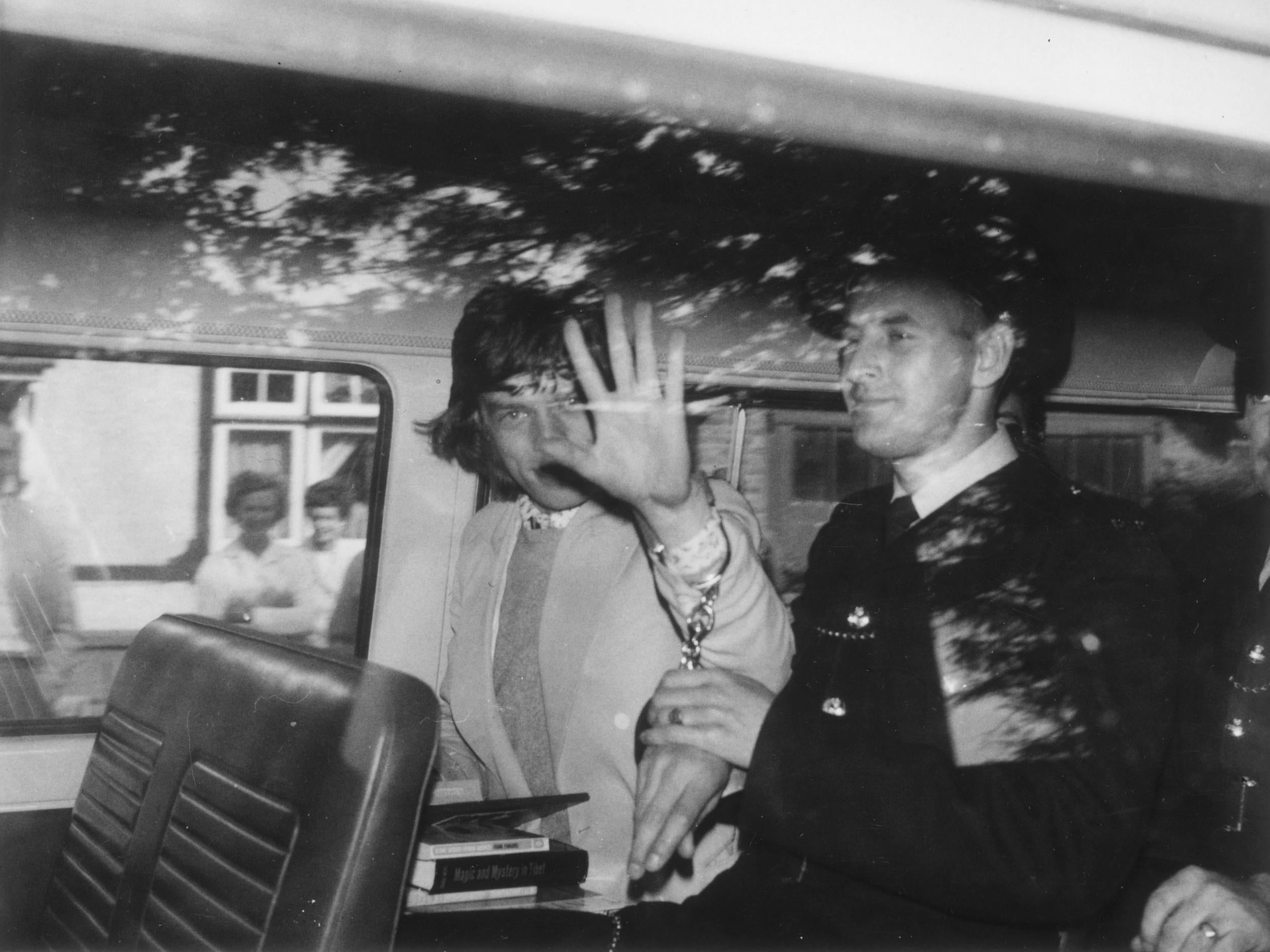 In cuffs but defiant, Jagger after being sentenced to three months in prison for possession of illegal pep pills in 1967