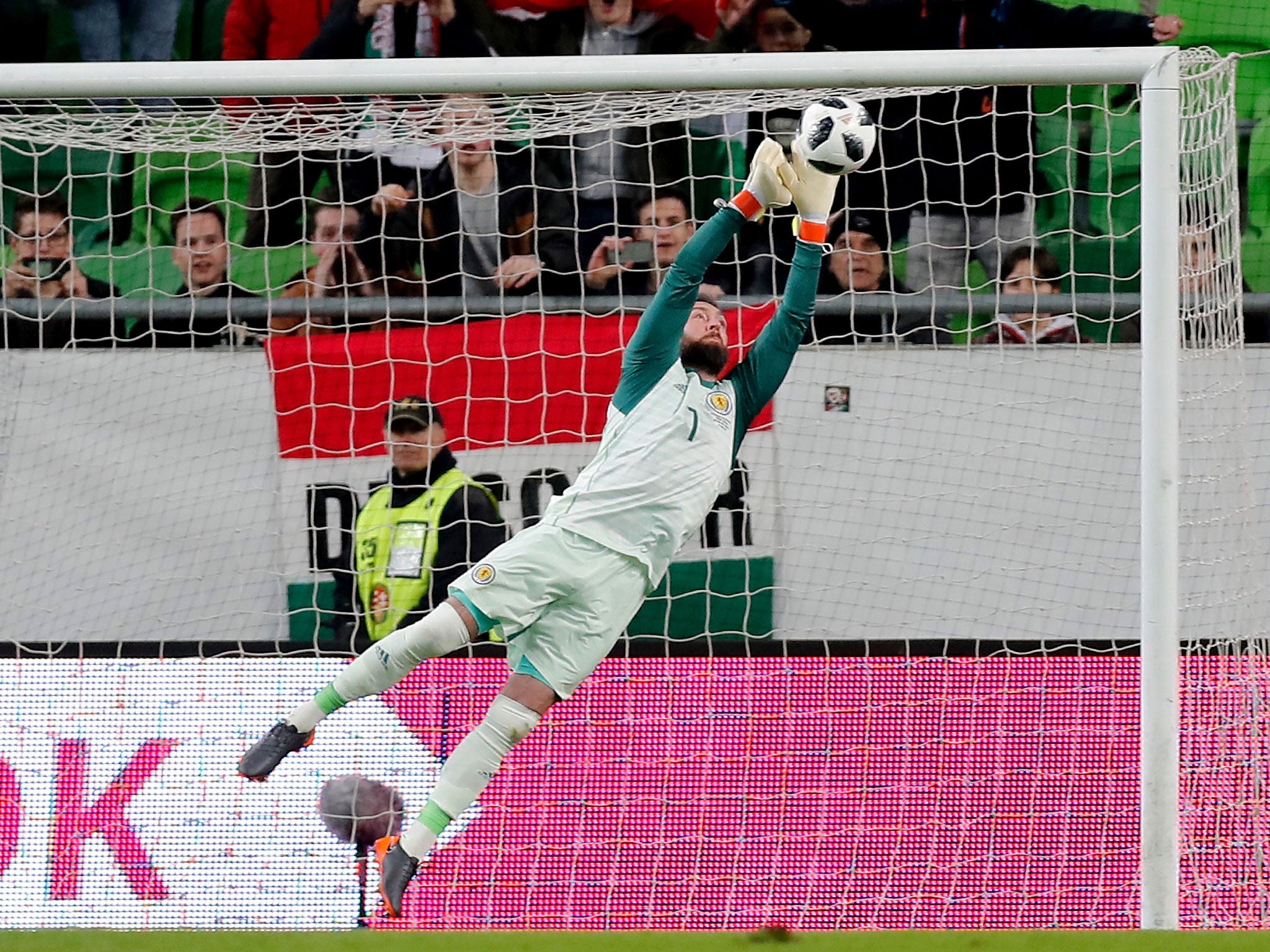 Allan McGregor dives to make a save for Scotland