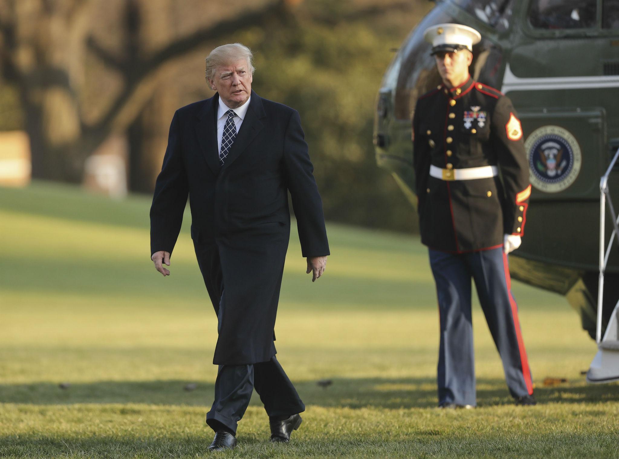 Donald Trump walks across the South Lawn of the White House in Washington