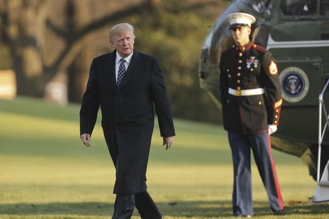 Donald Trump walks across the South Lawn of the White House in Washington