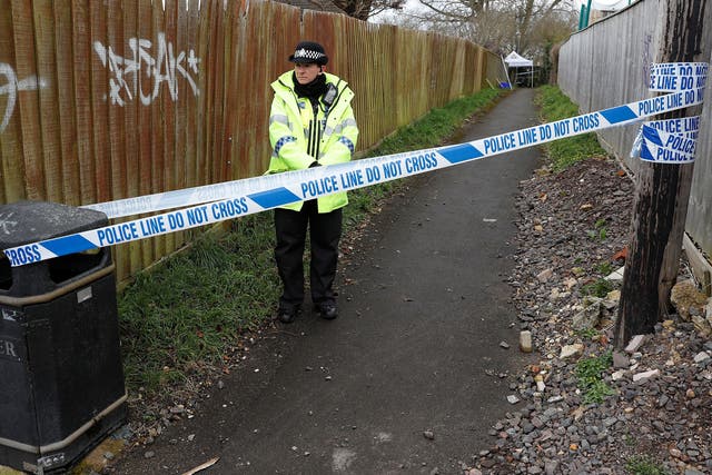 A police officer stands behind cordon tape in an alleyway which has been blocked off near the home of former Russian intelligence officer Sergei Skripal in Salisbury