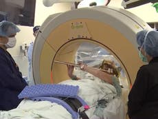 Woman plays flute while undergoing open brain surgery